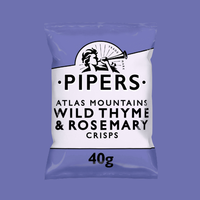 A close-up of crisps with fresh thyme and rosemary sprigs in the background.