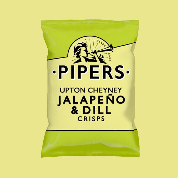 A close-up of crisps with fresh jalapeños and dill in the background.