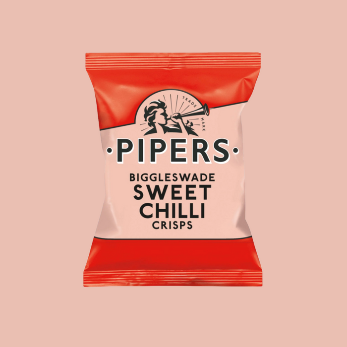A close-up of crisps with fresh chillies in the background.