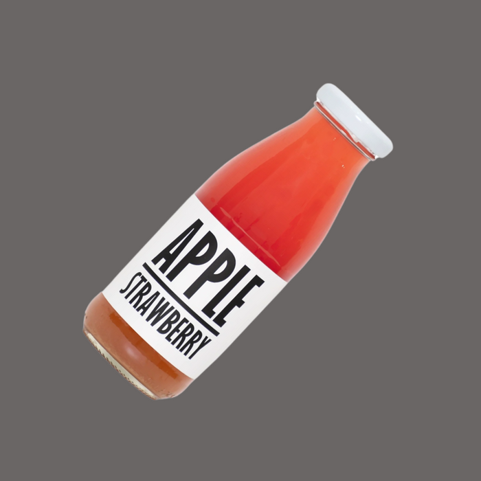 A glass of freshly poured apple-strawberry juice, showing its natural color and texture.