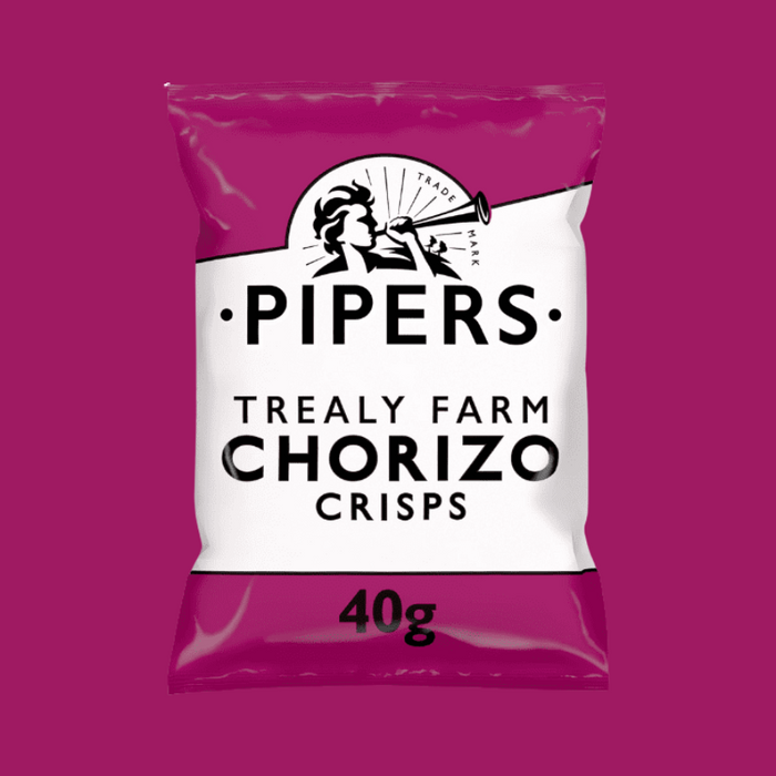 A close-up of crisps with sliced chorizo in the background.