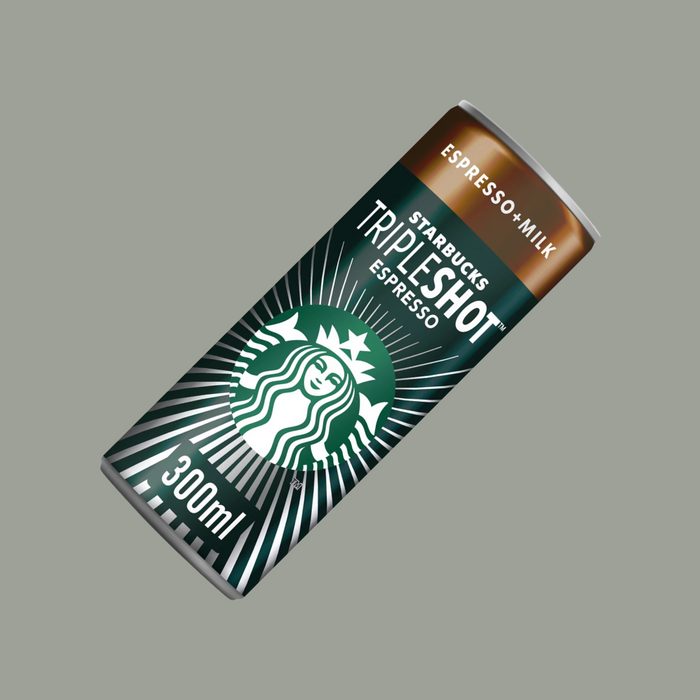 Hand gripping a Starbucks Tripleshot Espresso can next to workout gear