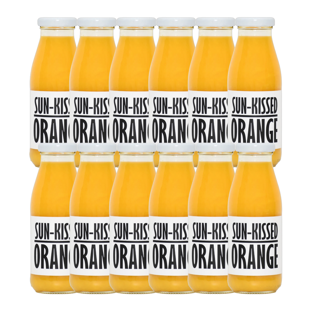 A bottle of Pressuice Sun-Kissed Orange Juice with fresh oranges in the background.