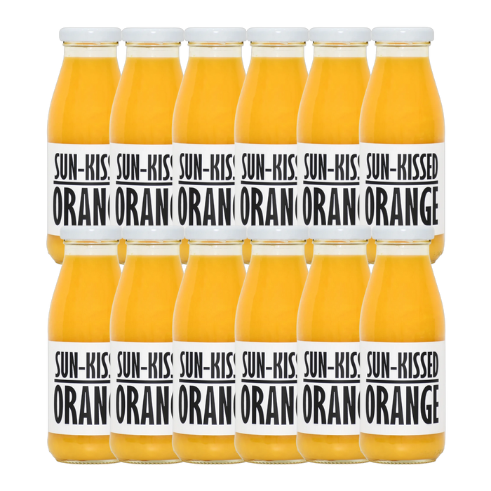 A bottle of Pressuice Sun-Kissed Orange Juice with fresh oranges in the background.