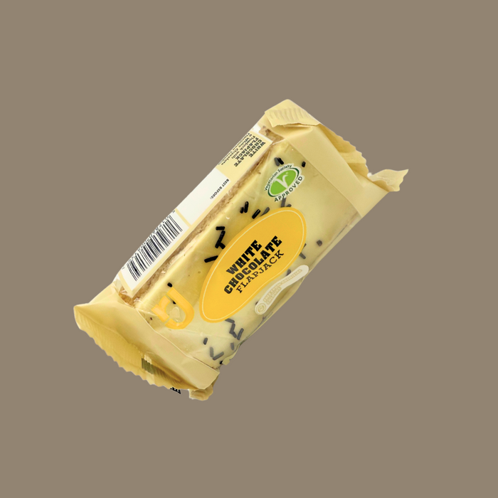 Open flapjack showing white chocolate layer over soft oat bar