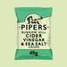 A close-up of golden crisps with a bottle of cider vinegar in the background.