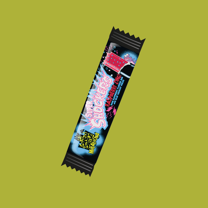 A hand holding a CCCM Weirds Shocker Bar against a fun candy display.