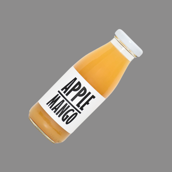 A glass of apple-mango juice with ice cubes, ready to enjoy.