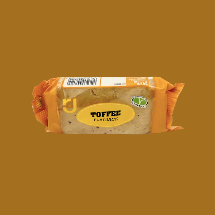 Row of 24 individually wrapped toffee flapjacks neatly arranged on countertop