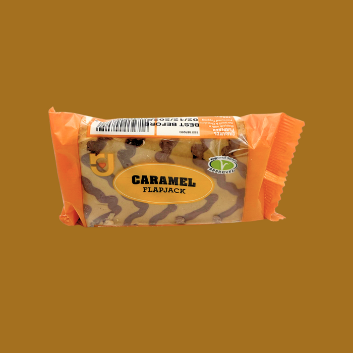 Opened individually wrapped caramel flapjack showing soft oat centre