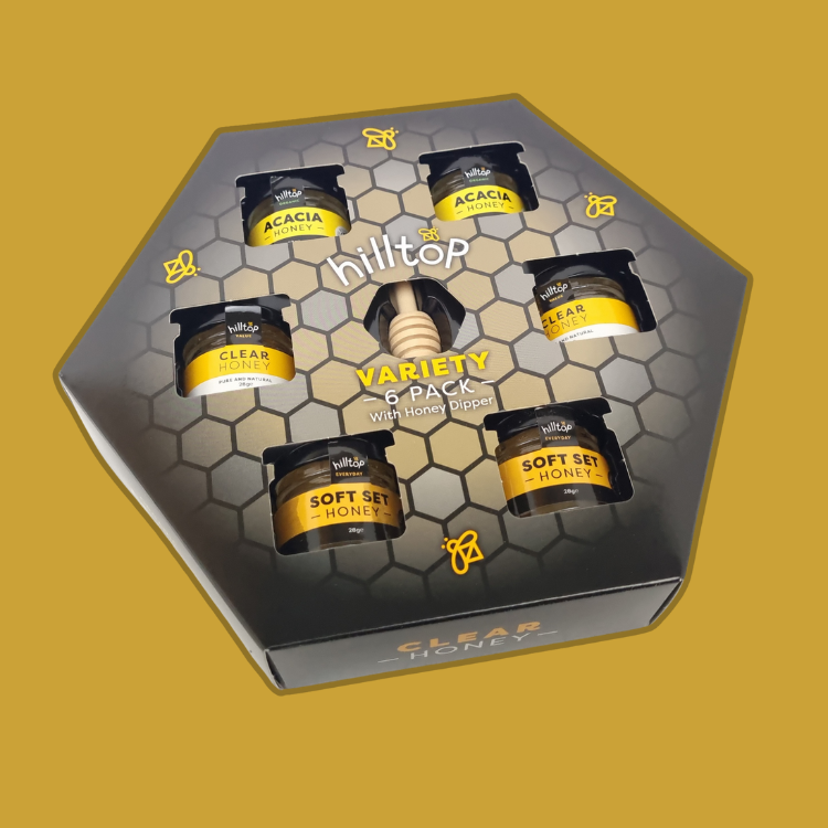 Assortment of acacia, clear, and set honeys in the Hilltop Honey Giftset