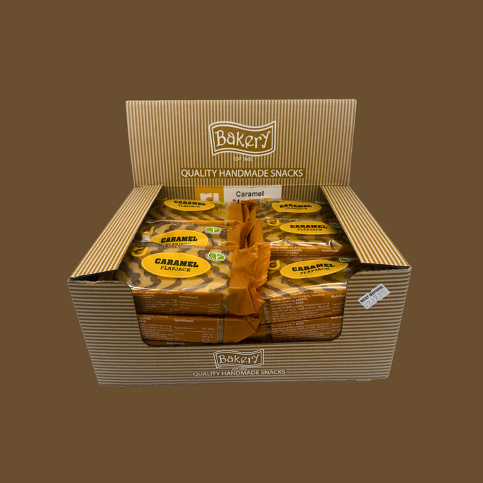 Stack of 24 RJ Caramel Flapjacks multipack next to coffee and fruit