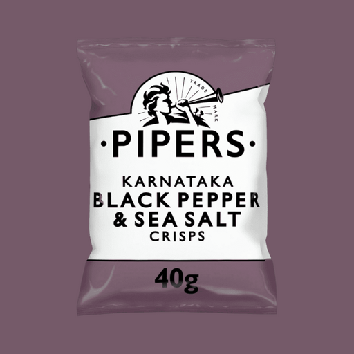 A close-up of crisps with fresh Tellicherry peppercorns and sea salt in the background.