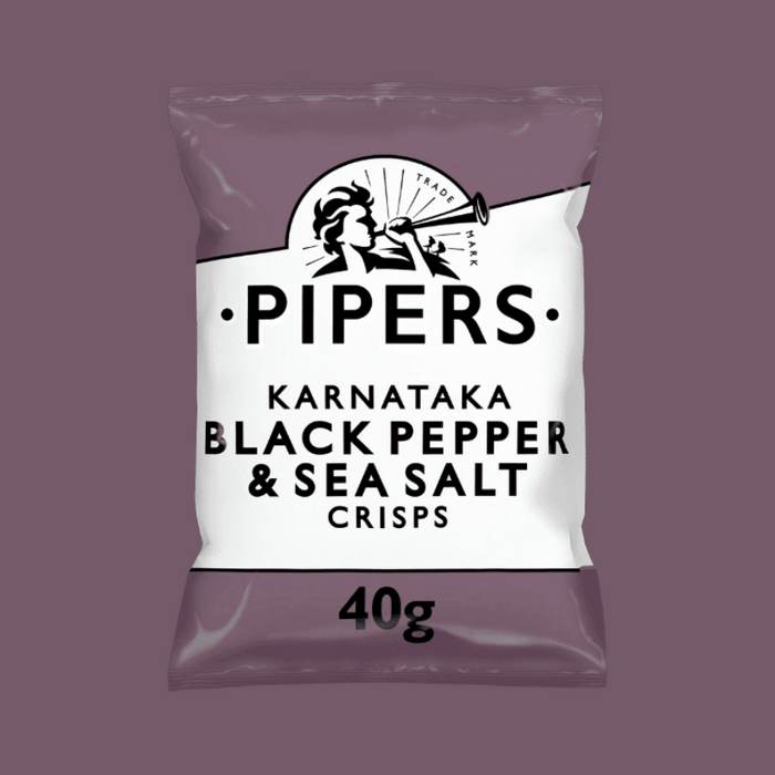 A close-up of crisps with fresh Tellicherry peppercorns and sea salt in the background.