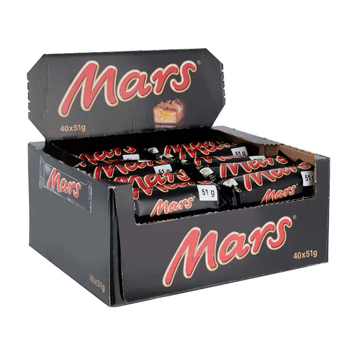 Opened Mars Bar next to a glass of milk on a kitchen counter

