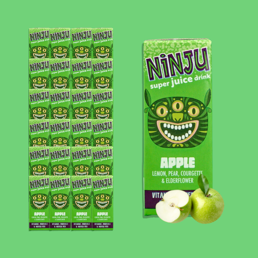 Close-up of Ninju Apple Super Juice with fresh apples and vegetables