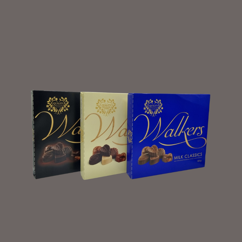 Walkers chocolate gift box placed on a festive table setting for Christmas.